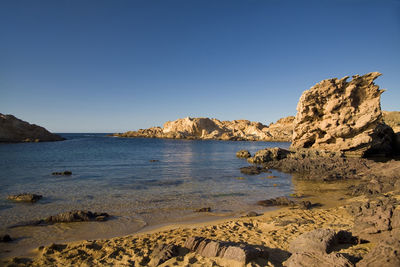 Scenic view of sea against clear blue sky