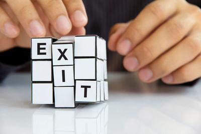 Close-up of hand holding puzzle cube with exit text