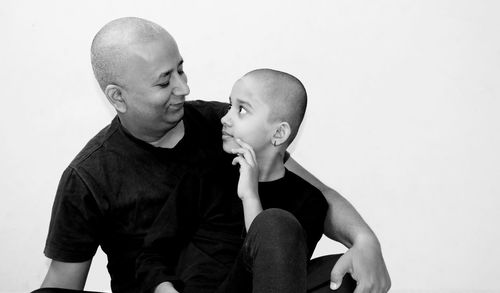 Father and son against white background