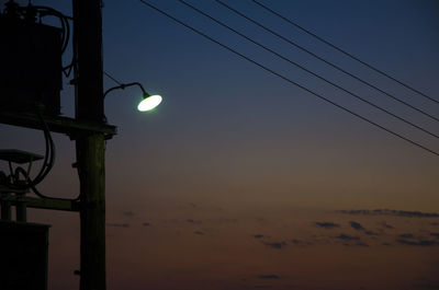 Low angle view of power lines against clear sky