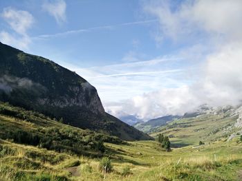 Scenic view of mountains against cloudy sky