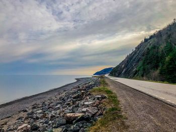 Road by sea against sky