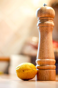 Close-up of lemon and shaker on table