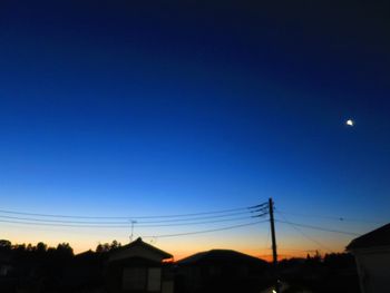 Silhouette of trees against clear sky at sunset