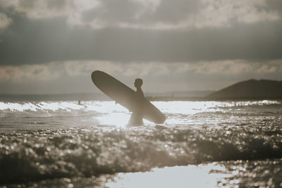 Man on beach against sky