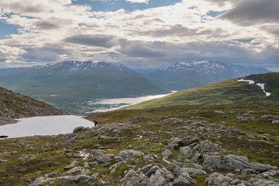 Scenic view of clouds over mountains and sea