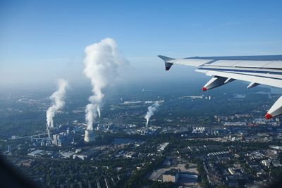 Cropped image of airplane flying over cityscape