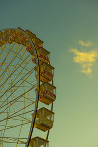 Low angle view of ferris wheel against sky