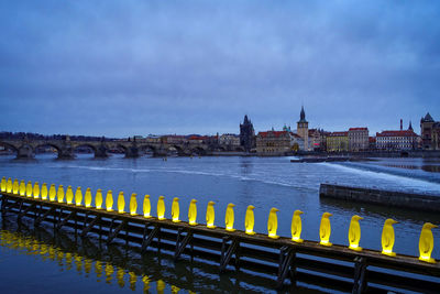 Bridge over river against buildings in city