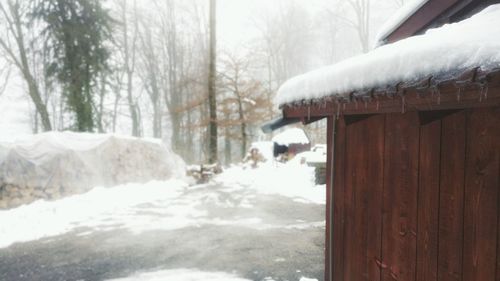 Snow covered houses against sky