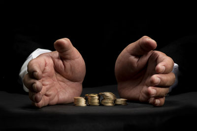 Close-up of a hand of person over black background