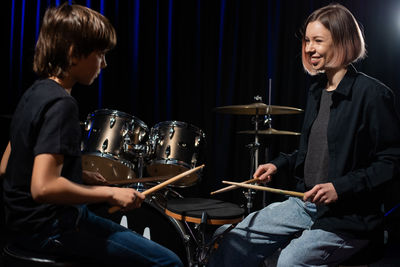 Young man playing guitar at music concert