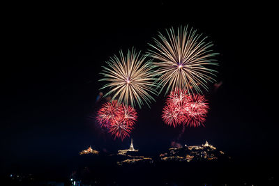 Low angle view of firework display at night