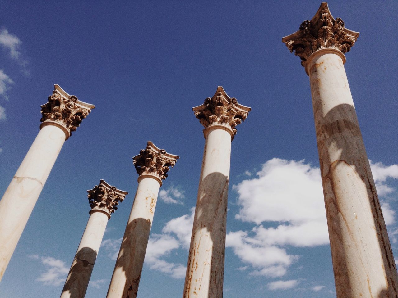 architecture, built structure, low angle view, building exterior, religion, architectural column, sky, history, tower, blue, famous place, travel destinations, column, place of worship, tourism, spirituality, lighthouse, outdoors, no people