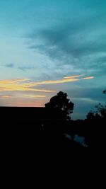 Silhouette trees against sky during sunset