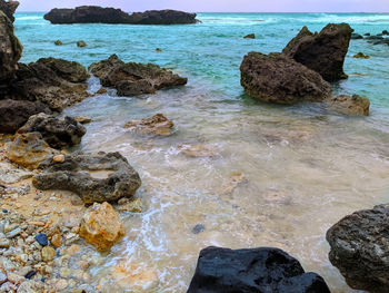 High angle view of rocks on sea shore