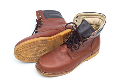 High angle view of cropped shoes over white background