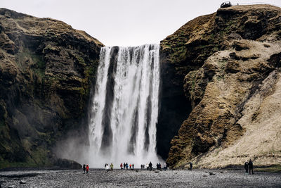 Scenic view of waterfall against rock formation