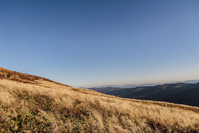 Scenic view of mountains against clear blue sky