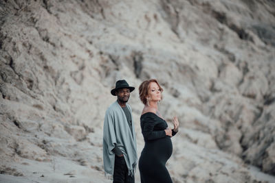 Portrait of a smiling young couple standing outdoors