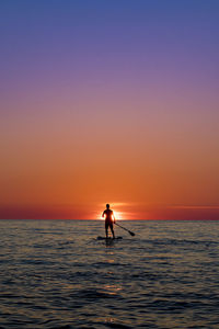 Standup paddle on sunset