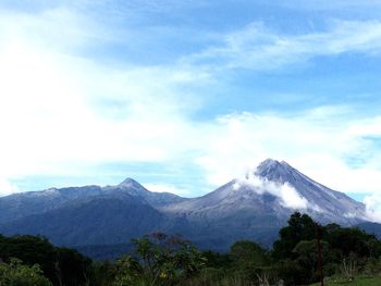 Scenic view of mountains against cloudy sky