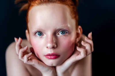 Portrait of a young girl on a blue background