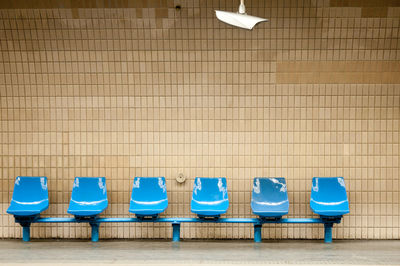 Empty chairs against tiled floor