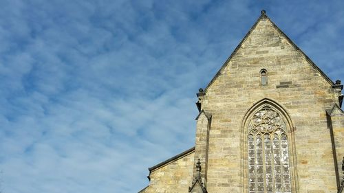 Low angle view of bell tower against sky