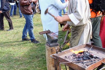 Men standing on barbecue grill