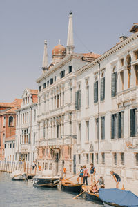 Family preparing a gondola in sunny venice canals