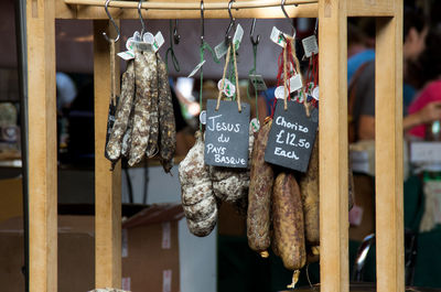 Close-up of sausages hanging at market stall