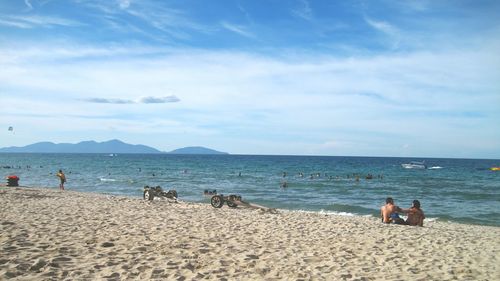 People on beach against sky