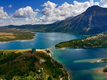 Scenic view of lake and mountains against sky