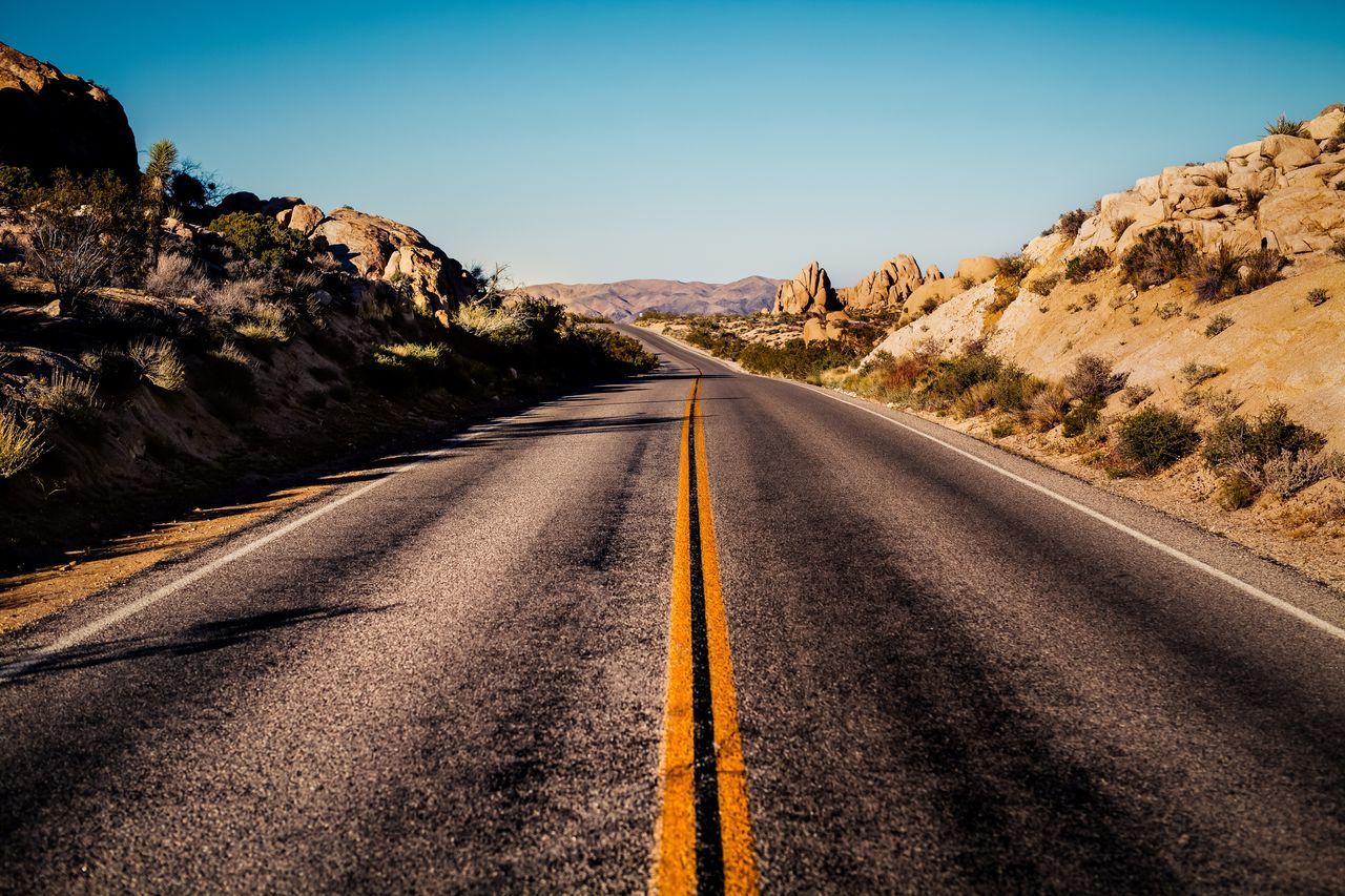 the way forward, diminishing perspective, transportation, vanishing point, road, clear sky, road marking, mountain, landscape, country road, tranquil scene, tranquility, asphalt, long, empty road, sky, non-urban scene, blue, nature, scenics