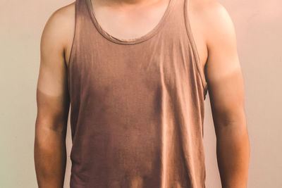 Midsection of woman standing against gray background