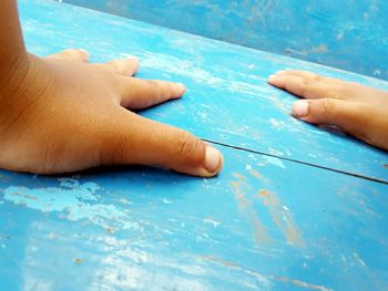 Cropped image of hands on wood