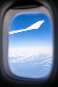 Aerial view of clouds seen through airplane window