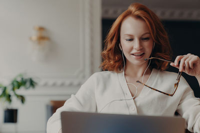 Young woman using mobile phone in office