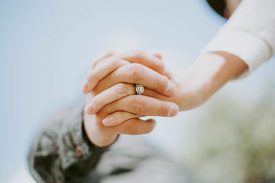 Midsection of couple holding hands