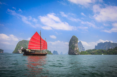 Boat sailing in sea against sky