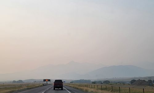 Car on mountain road against sky