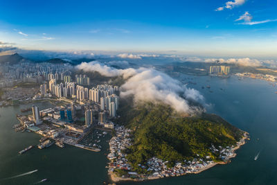 High angle view of buildings by sea against sky