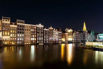 Reflection of buildings in city at night