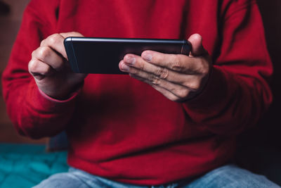 Midsection of man using mobile phone