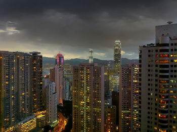 Illuminated cityscape against sky at night