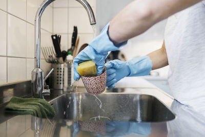 Midsection of man preparing food in kitchen at home