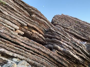 Low angle view of rock formation against sky