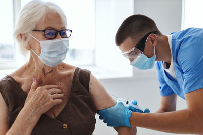 Doctor injecting vaccine to patient