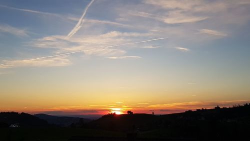 Silhouette landscape against sky during sunset